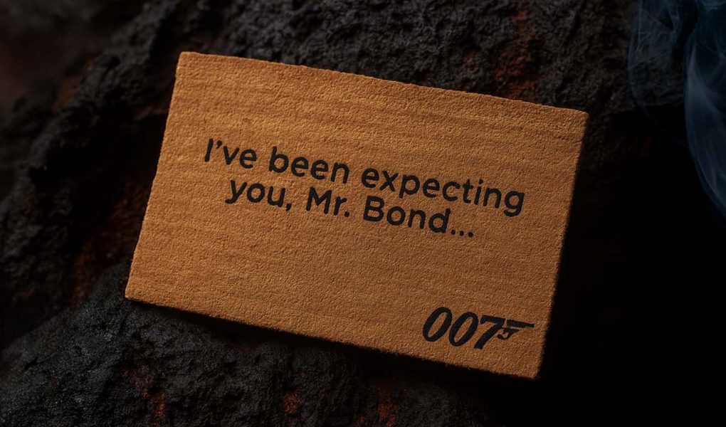 Official James Bond 007 doormat with the quote “I’ve been expecting you, Mr. Bond…” placed on a rugged lava stone ground.