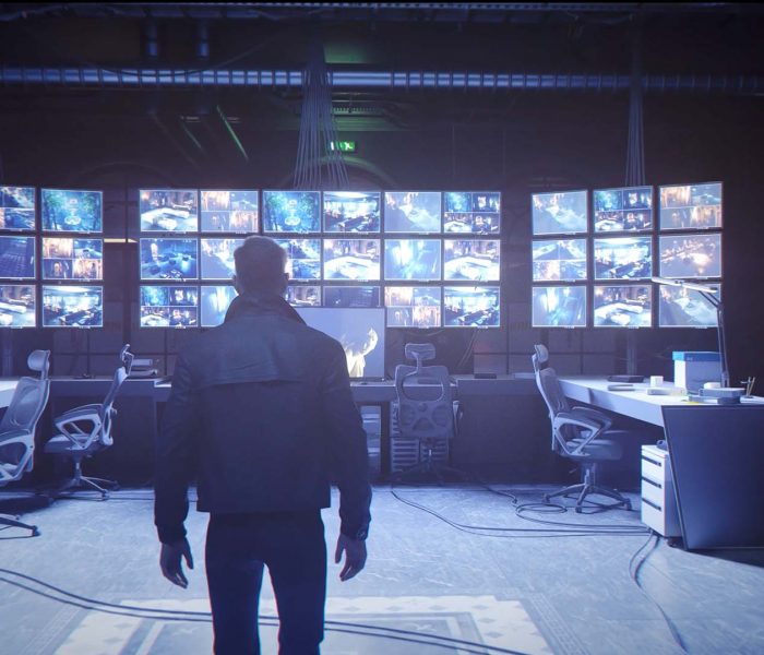 Bond enters a Webb Industries surveillance room filled with security camera screens in 007 First Light RTX trailer showcasing DLSS 4.5 and path tracing.